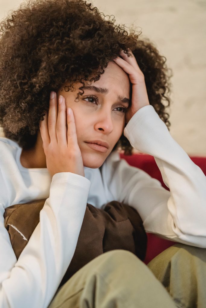 Woman sat looking stressed with anxiety